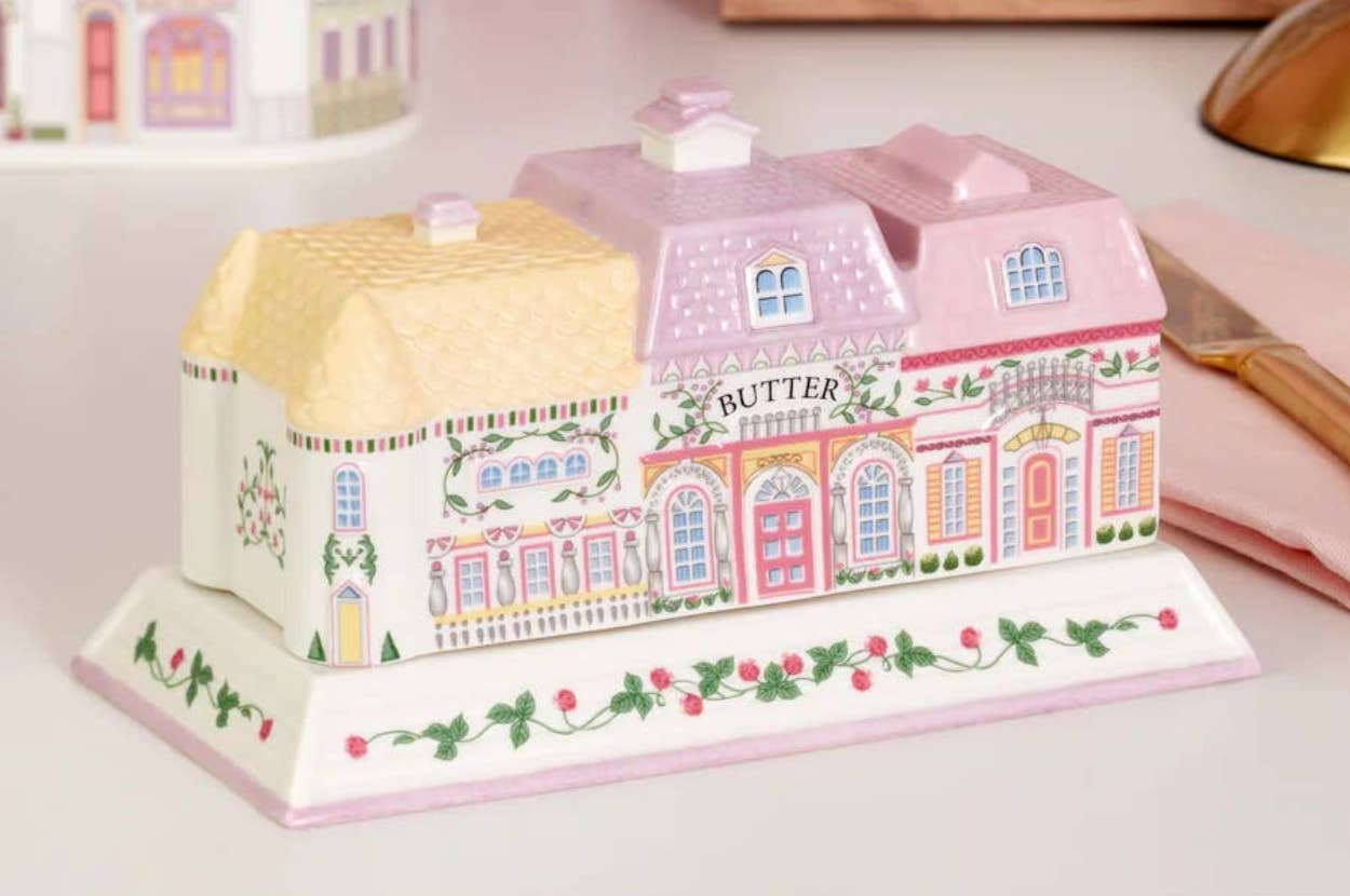 Decorative butter dish shaped like a whimsical cottage, featuring ornate doors and windows, ideal for enhancing a dining table setting