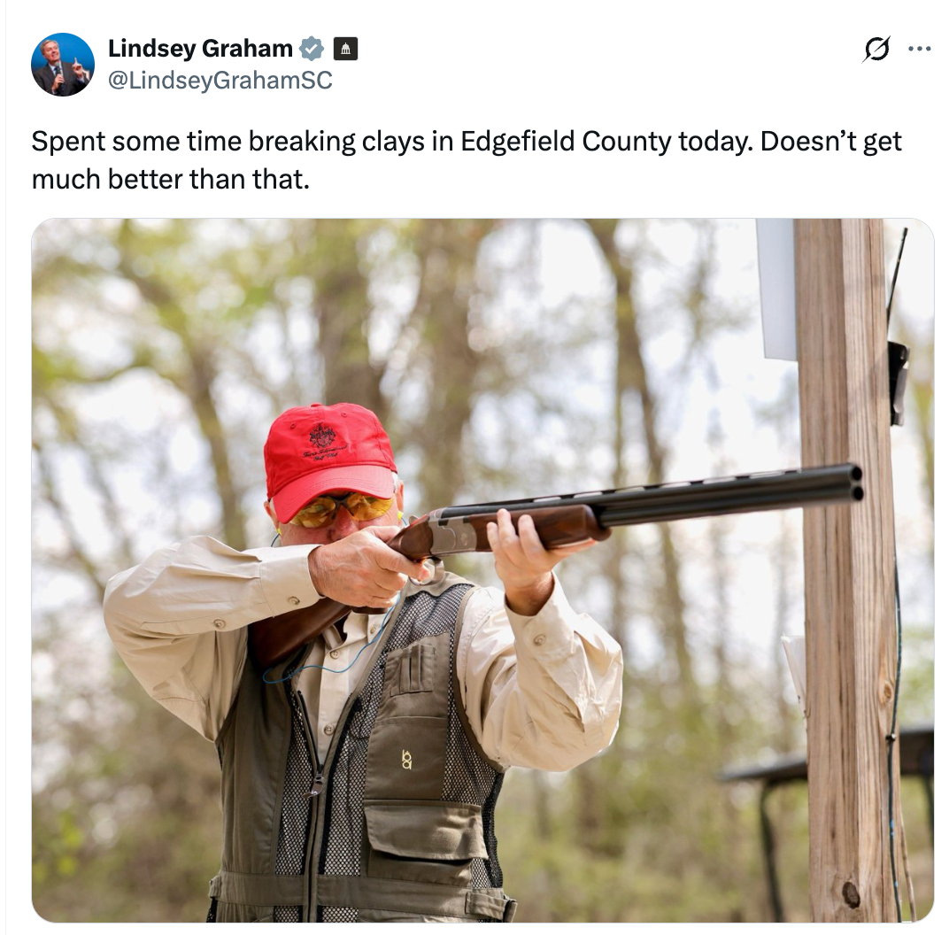 A idiosyncratic   wearing a reddish  headdress  and protective cogwheel  aims a shotgun outdoors, arsenic  described successful  the accompanying tweet text