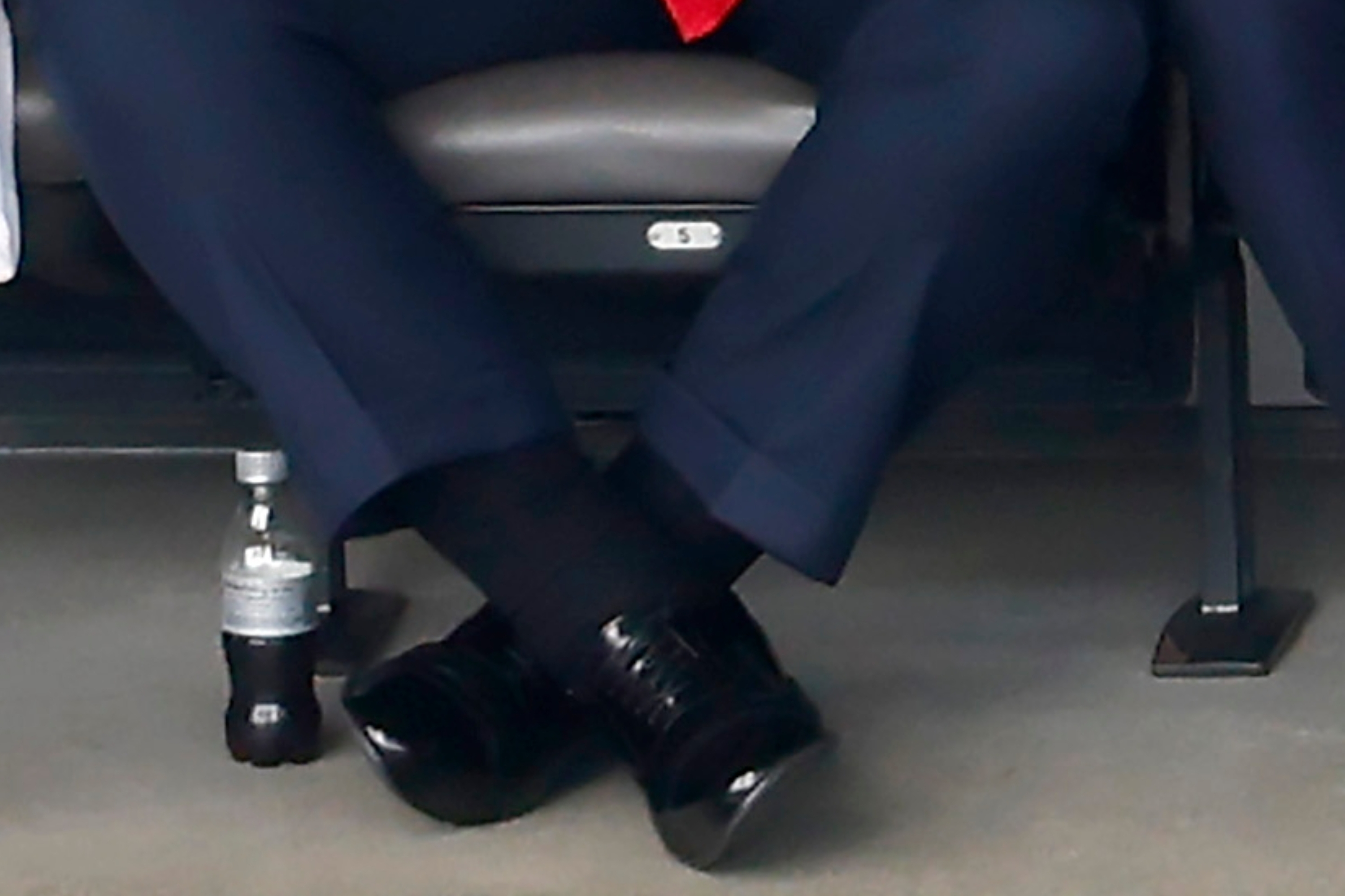 Four people, including a antheral   successful  a suit   and tie, beryllium   unneurotic  successful  a stadium box, engaged successful  conversation