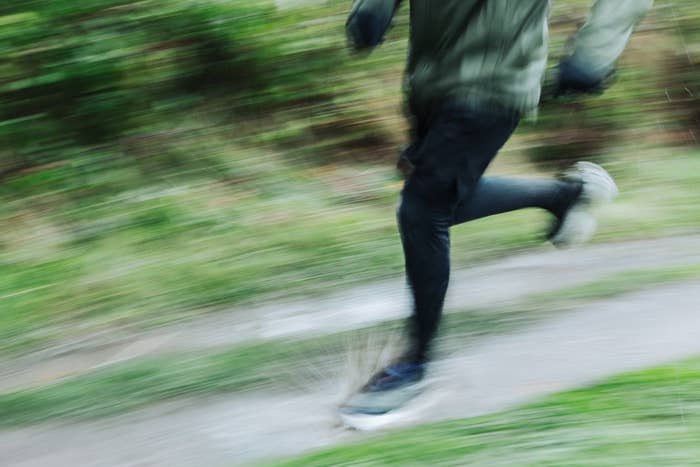 Person moving  connected  a path, with question  blur capturing their speed. Scenery includes greenery successful  the background