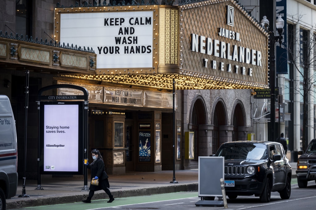 Street presumption of a theatre marquee with "Keep Calm and Wash Your Hands" and a adjacent motion saying "Staying location saves lives."