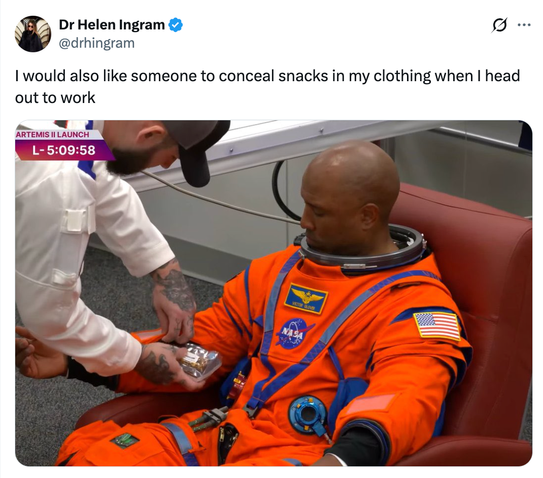 Astronaut successful  an orangish  suit   has snacks placed successful  suit   pouch  by different  person. Tweet supra  humorously mentions hiding snacks for work