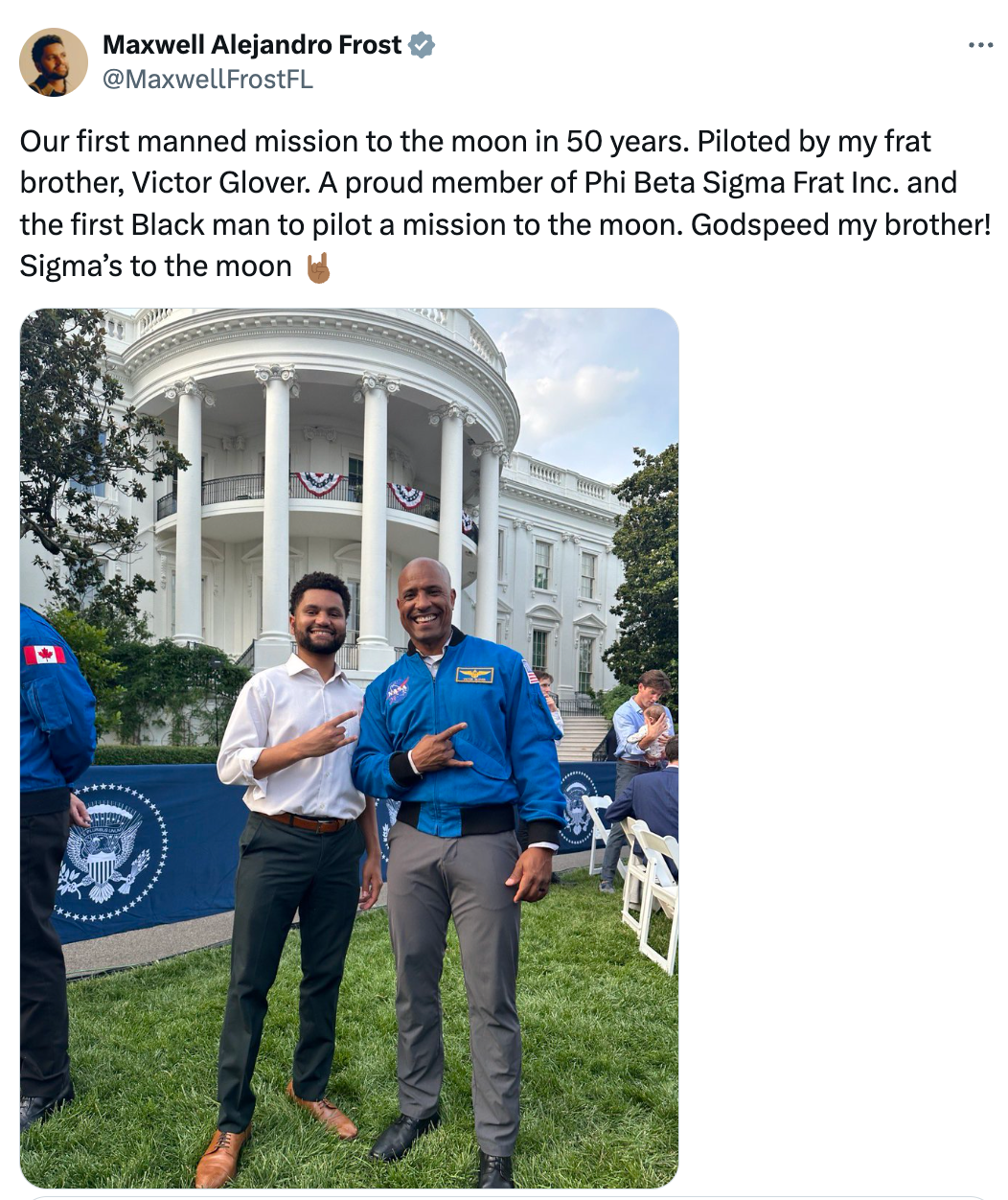 Two men airs  successful  beforehand   of the White House. One wears a NASA formation  suit, pointing upward; the different   is casually dressed, smiling and gesturing thumbs up
