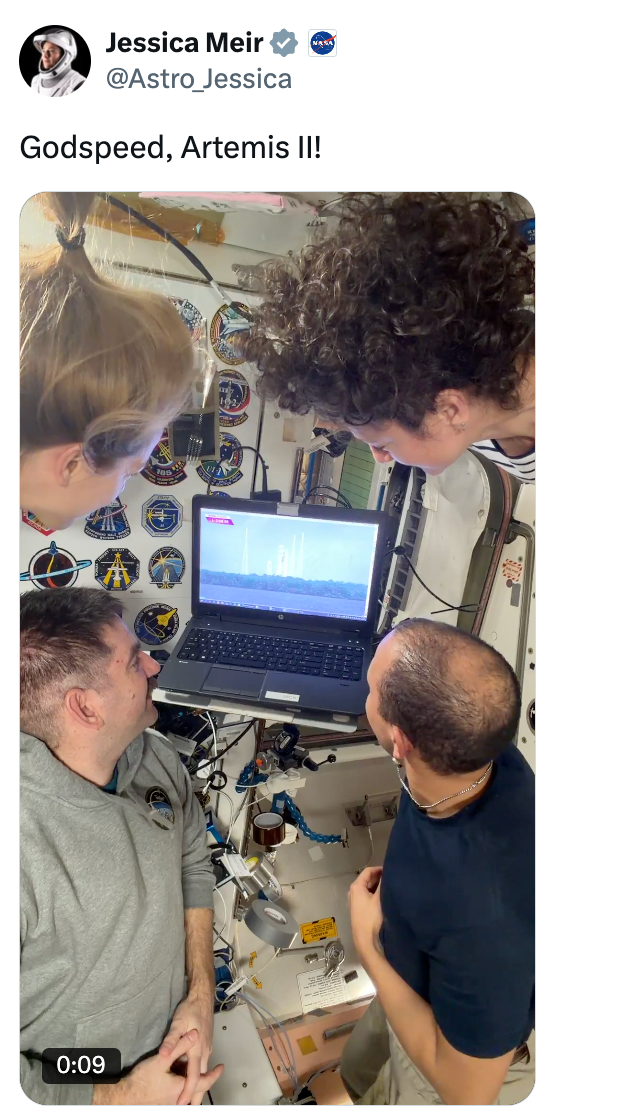 Three radical   are intently watching a rocket motorboat  connected  a laptop surface  wrong  a spacecraft
