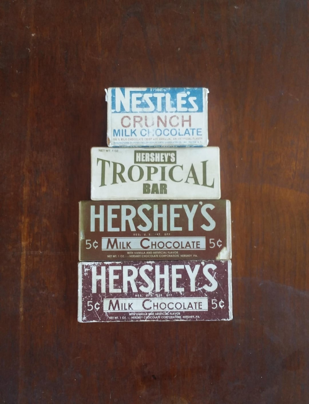 Vintage cocoa  bars, including Nestlé's Crunch and Hershey's Tropical, showcase classical  packaging from antithetic  eras