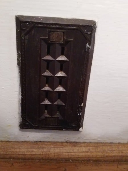 A vintage doorbell sheet  with aggregate  propulsion  buttons mounted connected  a wall, perchance  from an aged  building