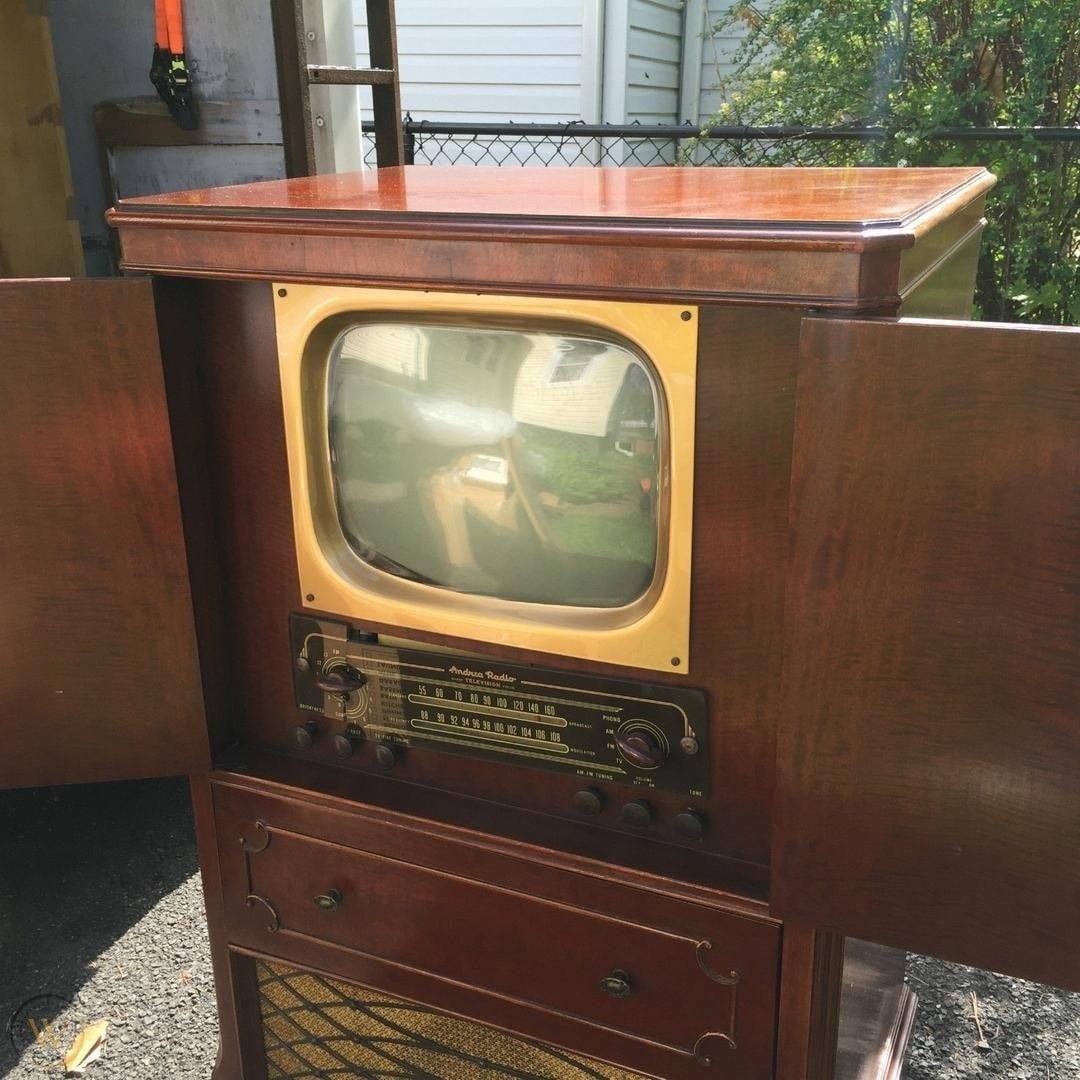 Vintage woody  tv  and vigor   console with broadside  cabinets open, featuring a surface  and dial controls, reflecting mid-20th period  design