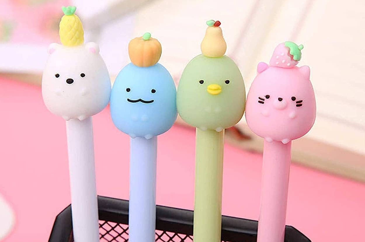 Cute novelty pens with fruit-themed animal topper designs: bear, mustache face, duck, and cat. Perfect for adding fun to your stationery collection