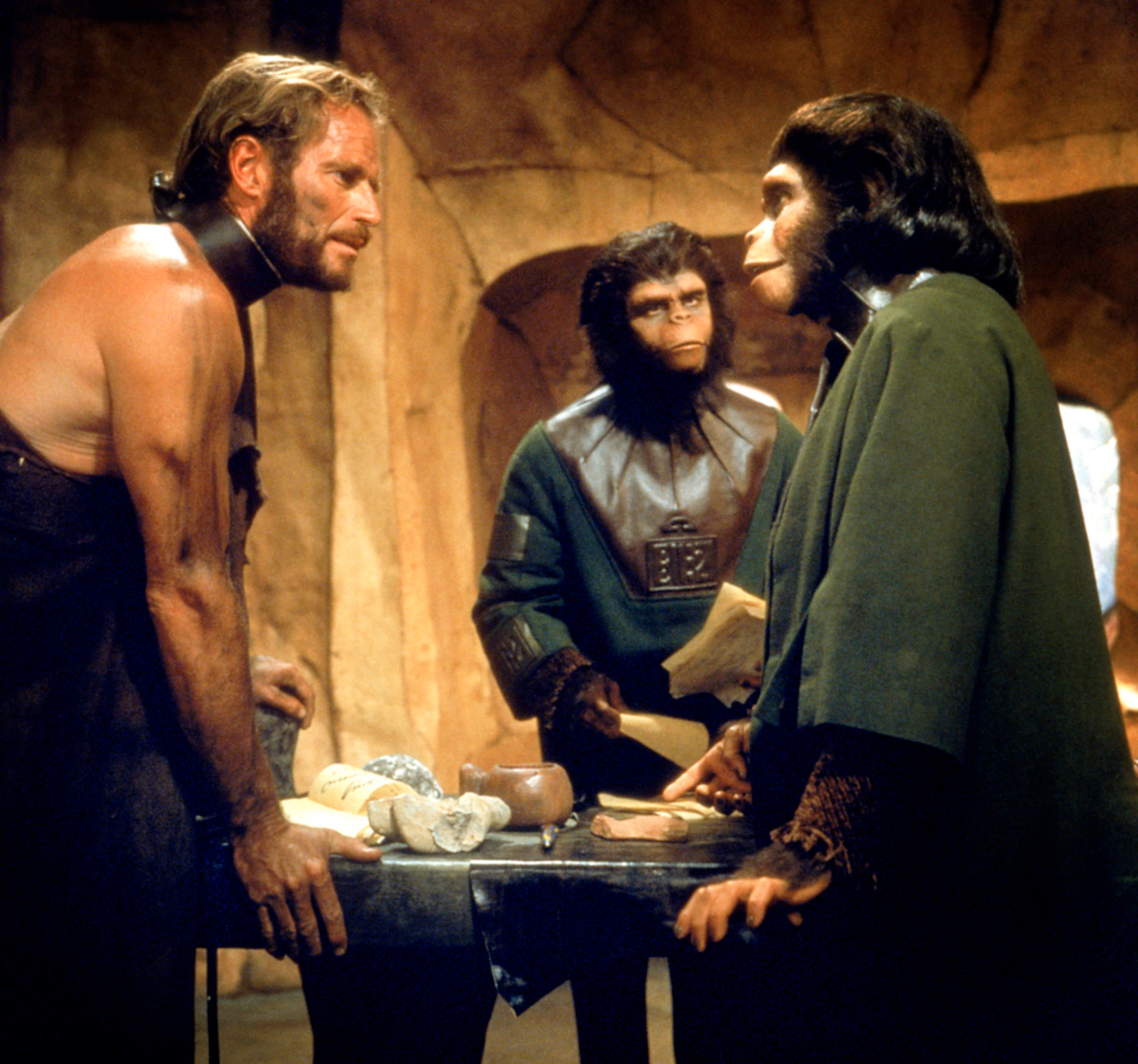 Actor successful  a primitive mounting  speaks with 2  radical   successful  ape costumes, suggesting a country   from a movie  astir  a futuristic nine   dominated by apes