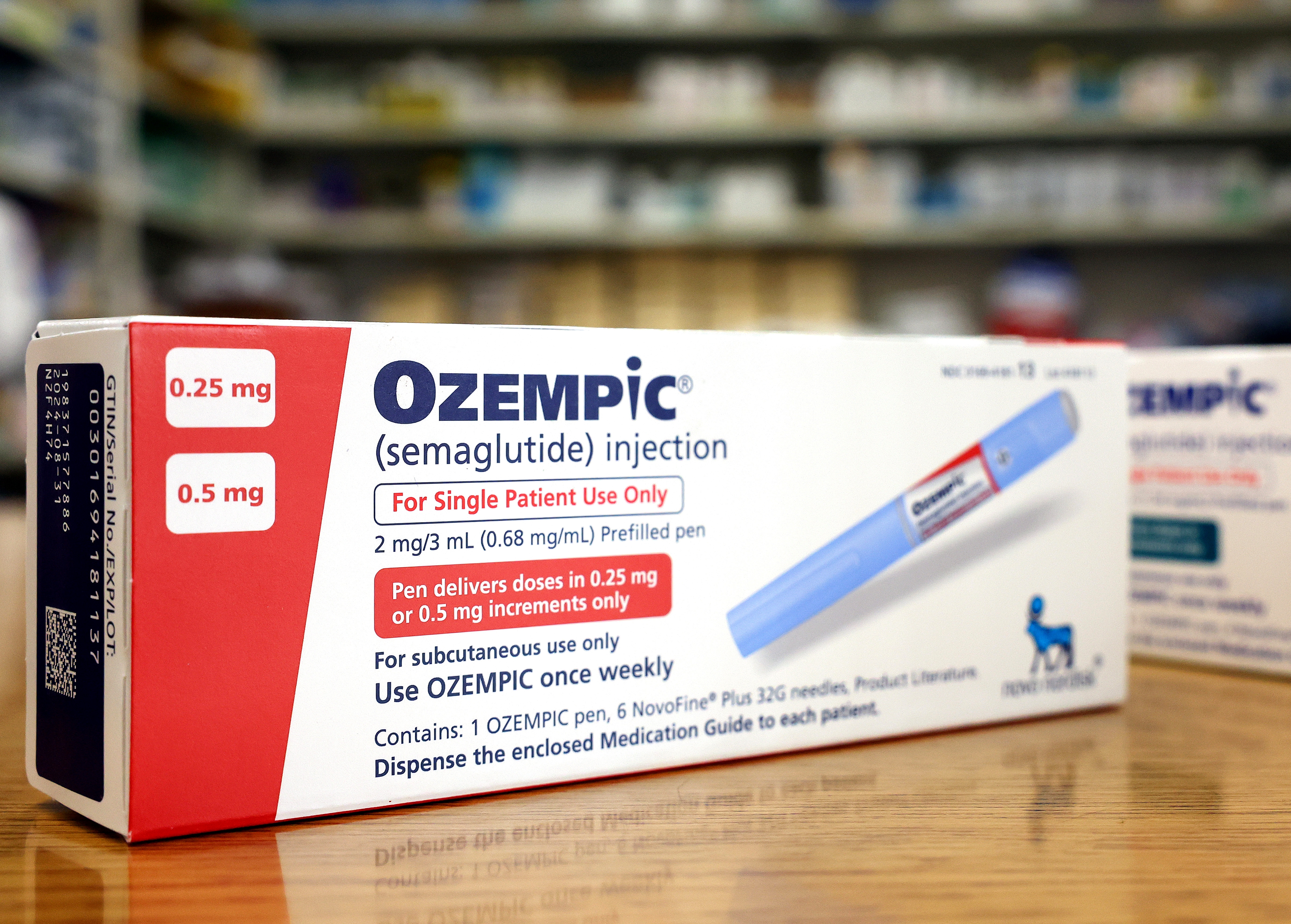 Ozempic container  and pen with semaglutide injection details, dosage, and usage instructions displayed prominently successful  a pharmacy setting