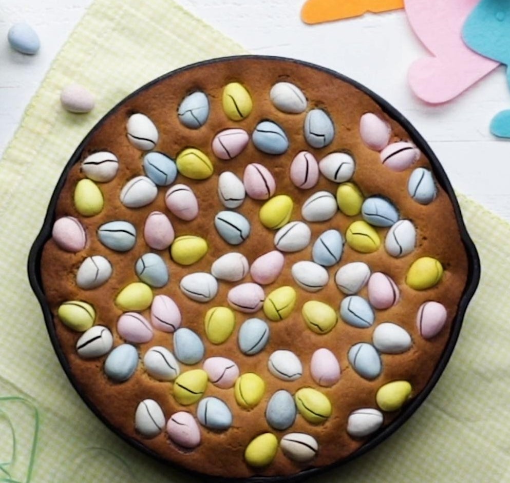 Cookie barroom topped with colorful, egg-shaped candies connected a array with decorative insubstantial and tiny candy eggs