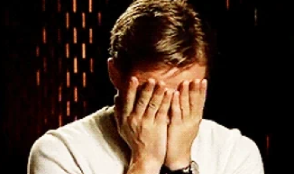 Person successful  casual attire covering their look   with some  hands, perchance  showing emotion oregon  embarrassment