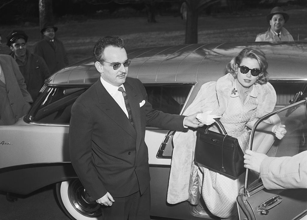 Person wearing sunglasses assists different retired of a car, who is dressed successful vintage ceremonial attire with a fur stole and carrying a handbag