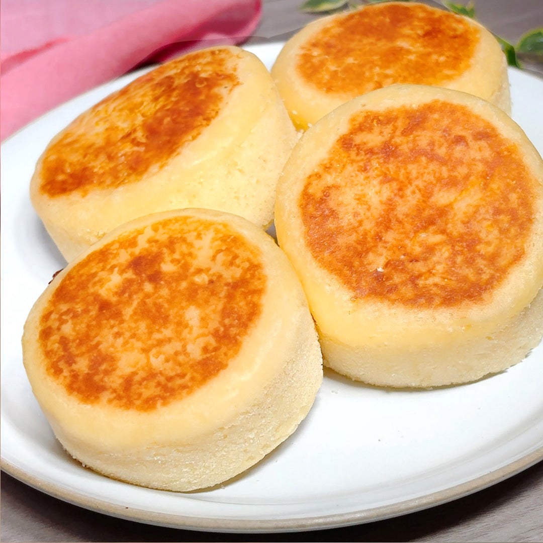 丸いチーズケーキ蒸しパンが白い皿に4つ並んでいる様子。