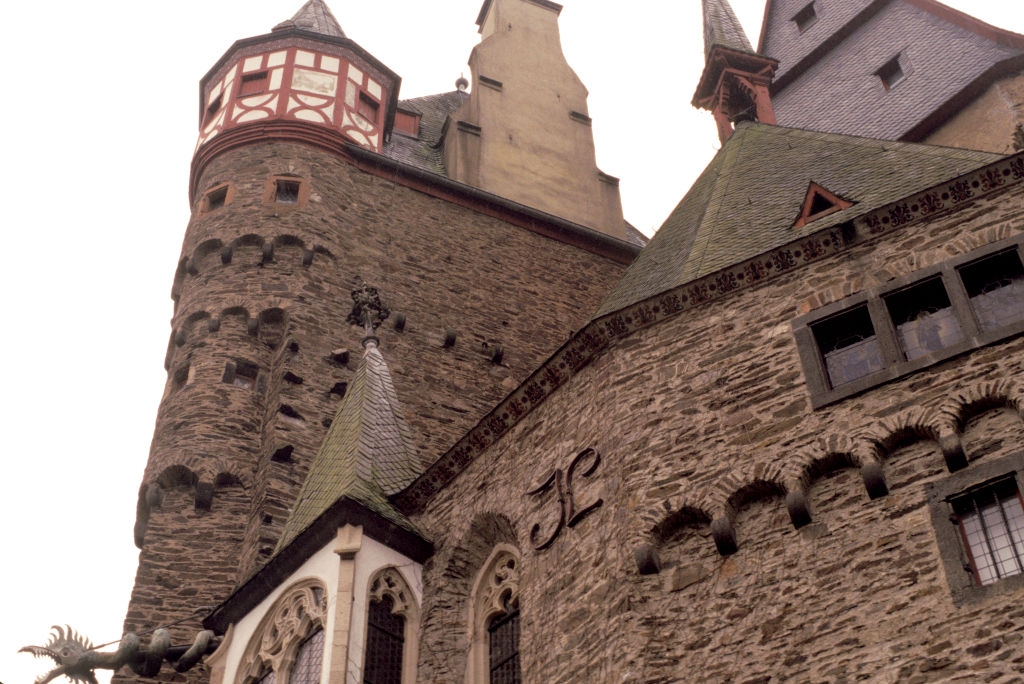 Historic chromatic castle with turrets and intricate architectural details. Gothic and medieval plan elements are prominent
