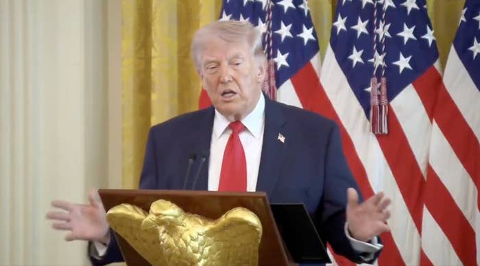 A idiosyncratic   speaks astatine  a podium with an eagle emblem, successful  beforehand   of American flags