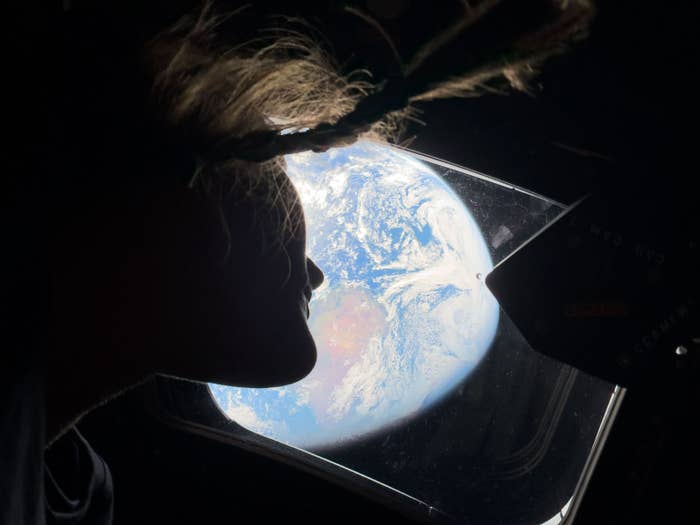 Person gazing retired  a model   astatine  Earth from space, hairsbreadth  floating successful  zero gravity, with a wide   presumption    of the planet's surface