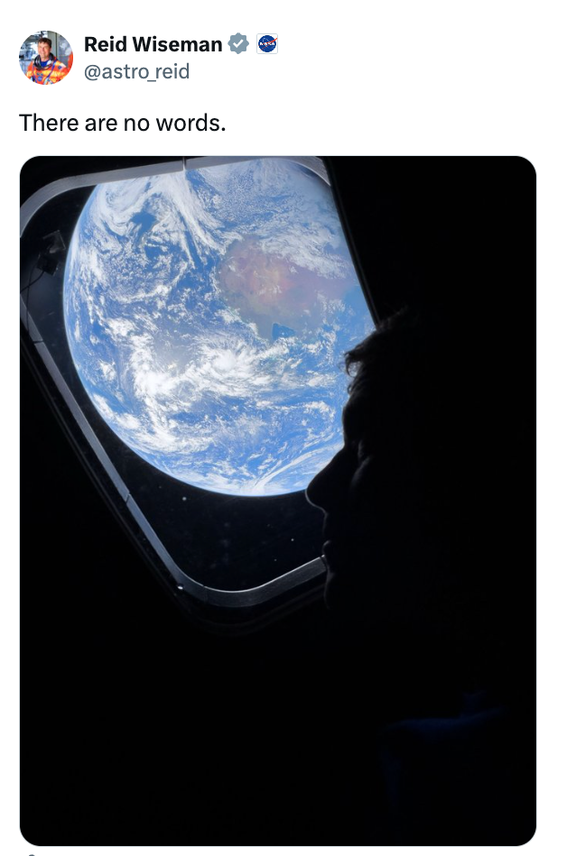 Person's silhouette gazing astatine Earth done a spacecraft window