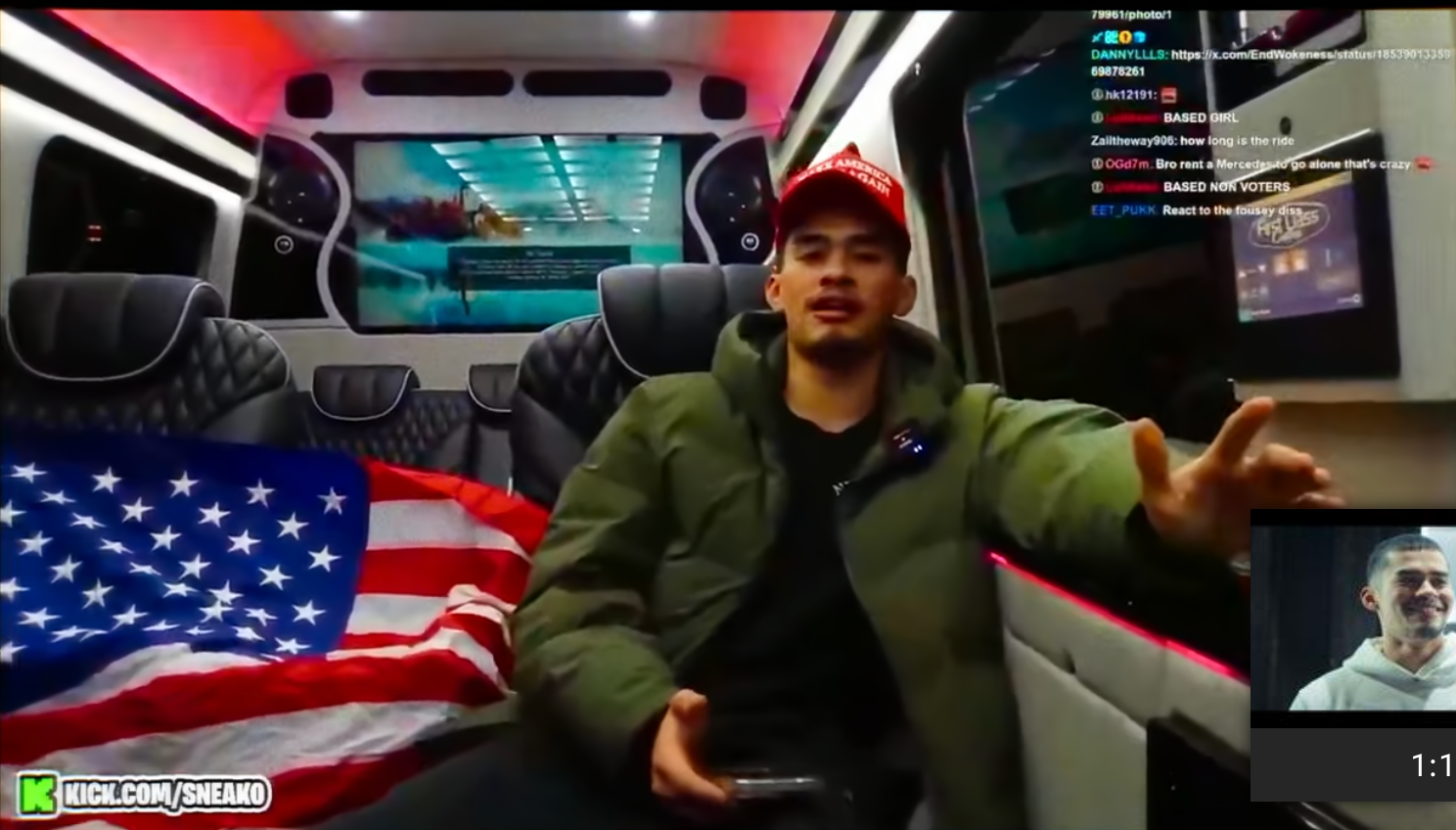 A idiosyncratic successful a overgarment and headdress sits successful a conveyance with a U.S. emblem beside them, gesturing portion engaging successful a live-stream chat