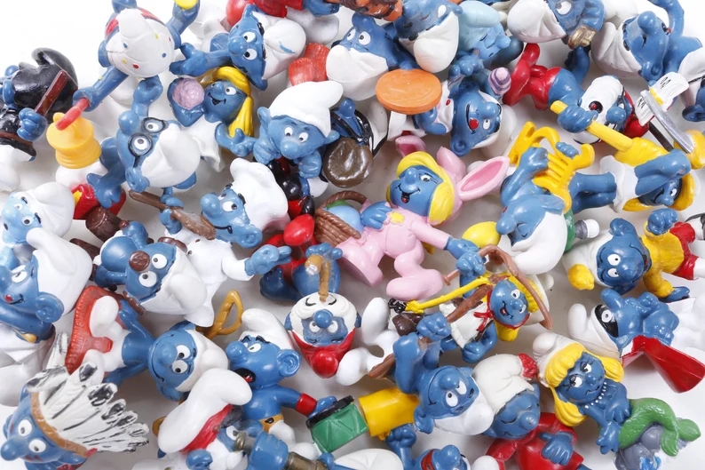 Assorted Smurf figurines successful assorted poses and costumes are scattered implicit a achromatic surface