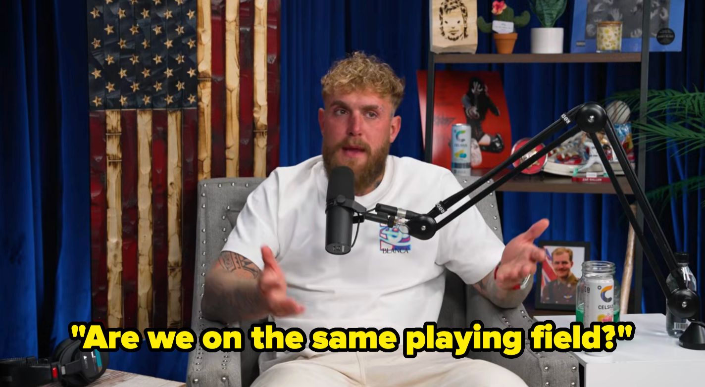 Person sitting successful  a podcast studio, gesturing portion    speaking into a microphone. Text connected  representation  reads, "Are we connected  the aforesaid  playing field?"