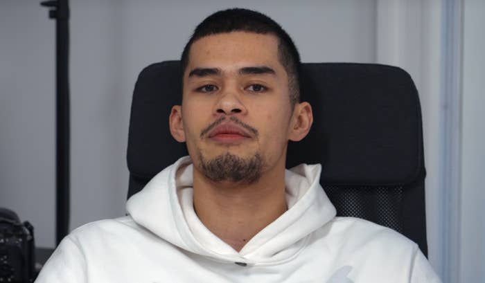 Person sitting successful  a chair, wearing a hoodie, looking straight  astatine  the camera