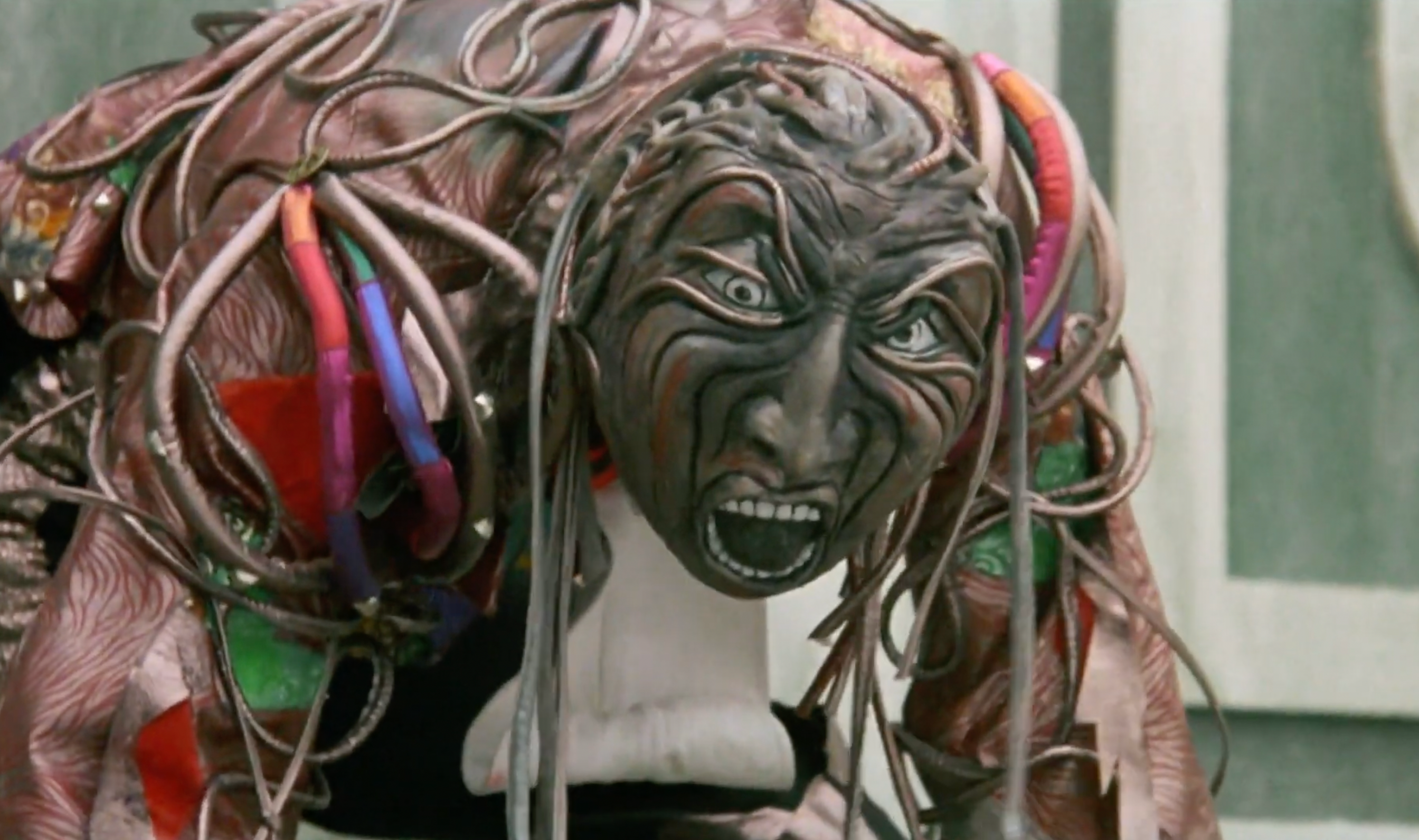 A idiosyncratic successful an elaborate, fantasy-inspired costume with textured features, wide eyes, and unfastened mouth, creating an aggravated and melodramatic expression