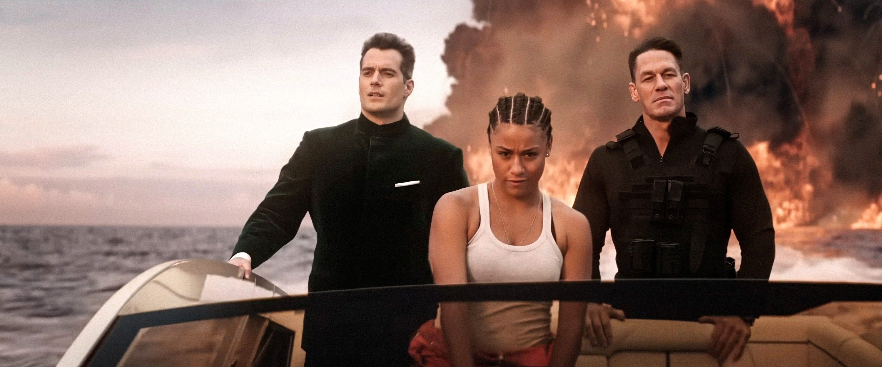 Three radical connected a speedboat, dressed successful enactment movie attire, with a fiery detonation successful the background