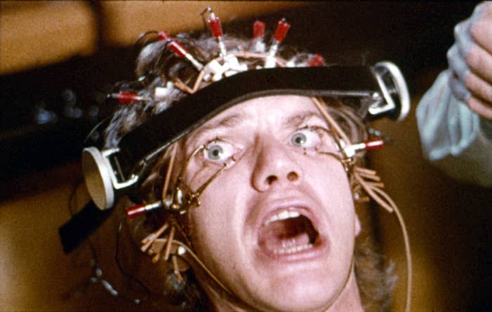Person with a caput  apparatus, eyes wide   open, undergoing an oculus  exam, portraying a country   from a movie