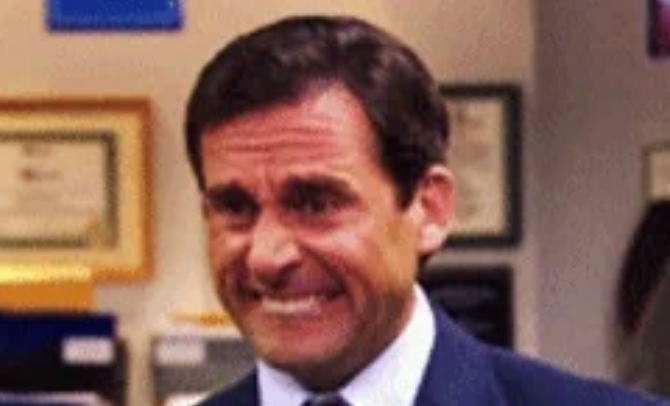 Man successful bureau grimacing, eyes squinting, arsenic if reacting to thing awkwardly tense oregon uncomfortable. Background includes bureau decor