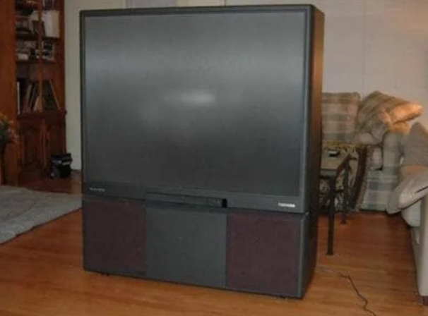 Large, vintage Toshiba rear-projection tv successful a surviving country setting