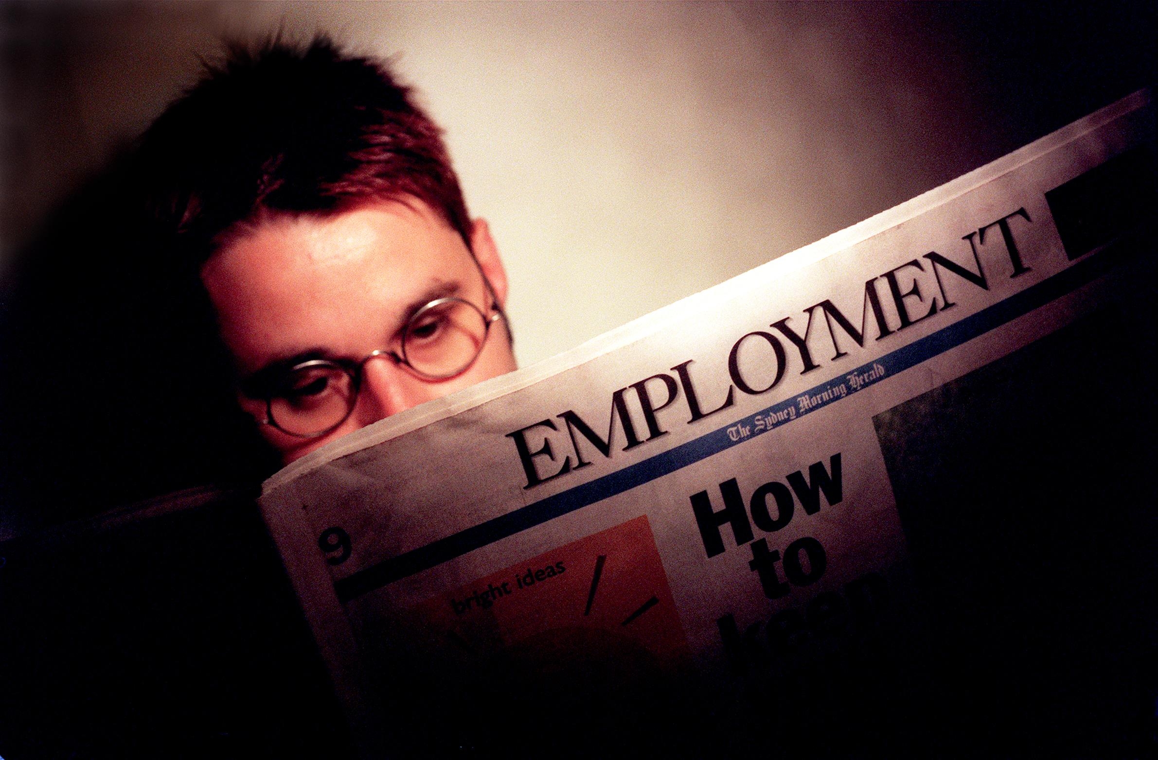 Person speechmaking a paper with the header "Employment" prominently visible