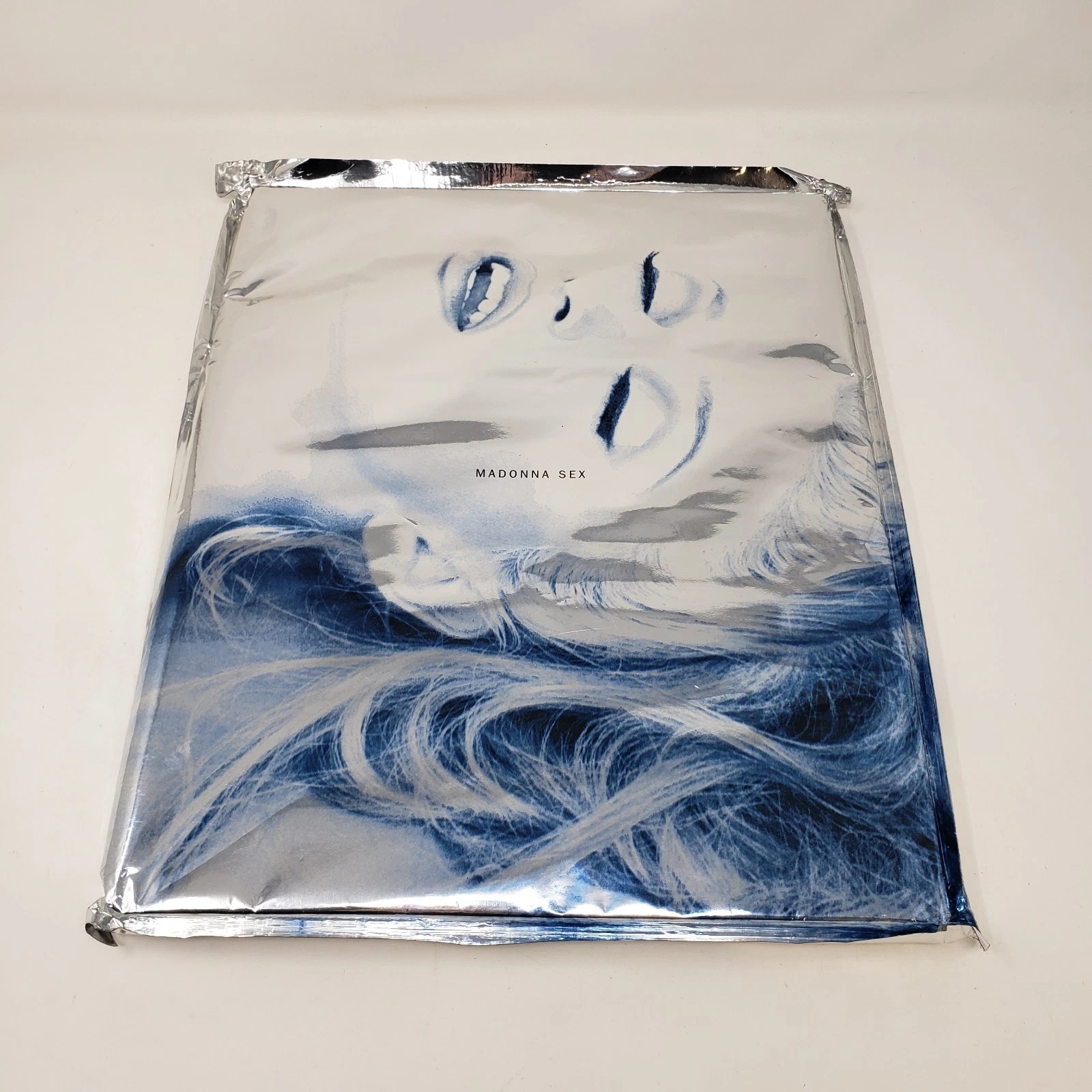 Madonna's "Sex" publication screen featuring her black-and-white representation with an overlay of metallic and bluish accents