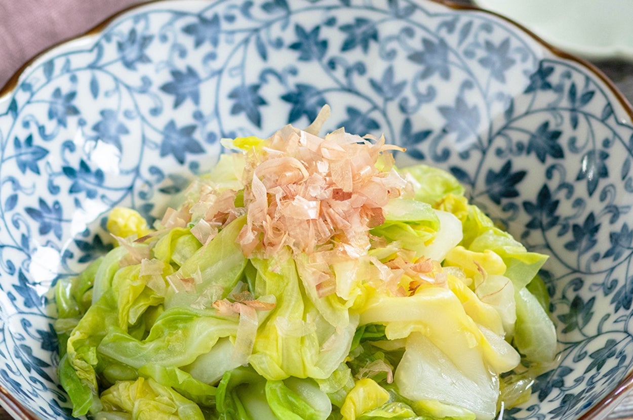 キャベツと鰹節が盛られた模様入りの器に入ったサラダ。和風の上品な盛り付け。