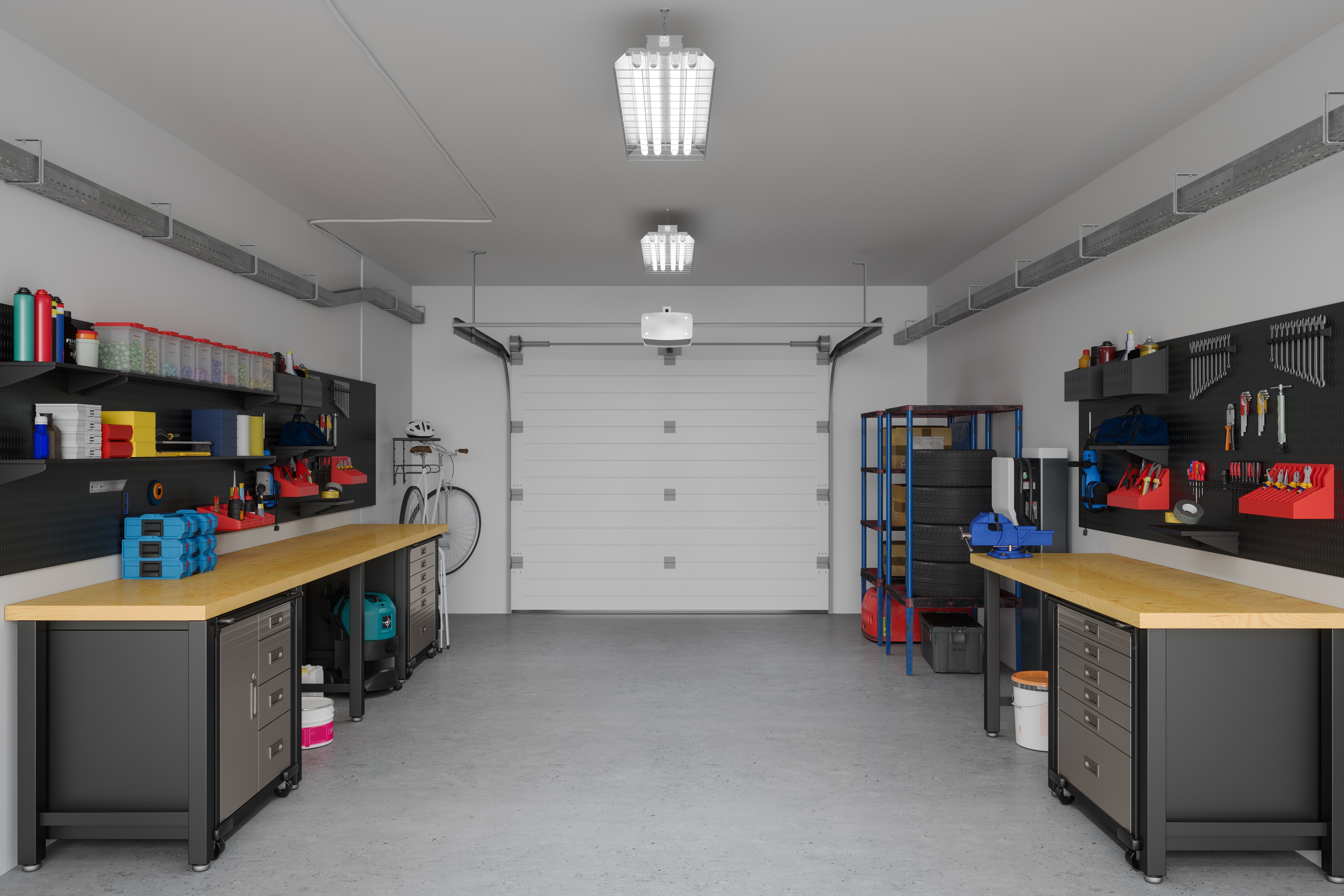 Organized garage workspace with two workbenches, shelves, tools, and supplies neatly arranged