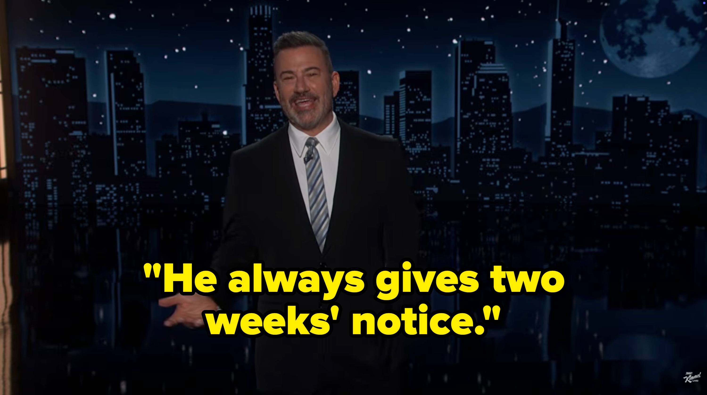 A antheral   successful  a suit   stands connected  a signifier    with a metropolis  skyline backdrop, gesturing during a late-night speech   amusement   monologue