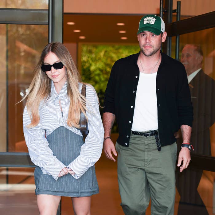  1  wears a striped blouse and skirt, the different   wears a cap, achromatic  jacket, and greenish  pants