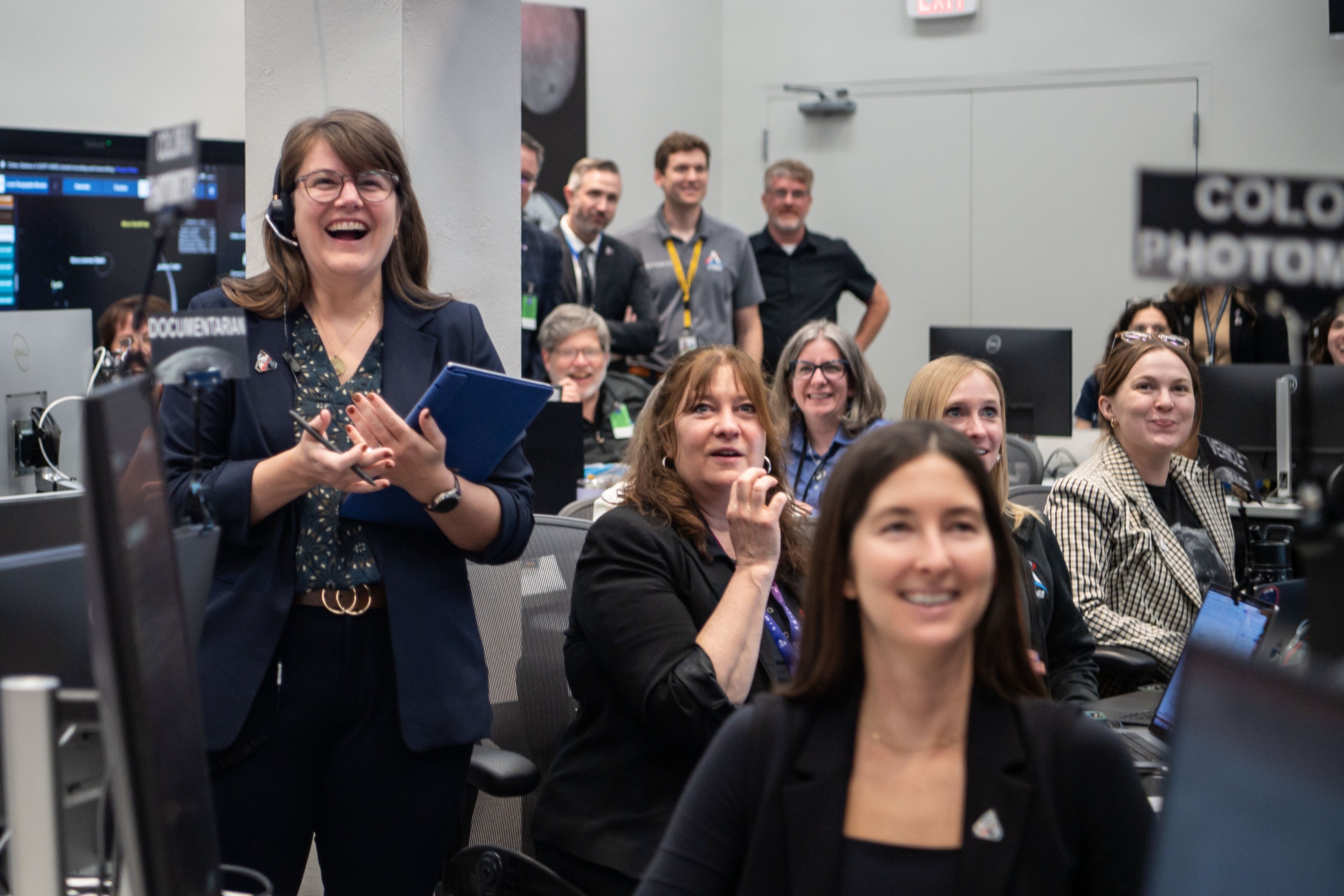 Group of radical successful a power country celebrating and smiling, with screens and computers visible