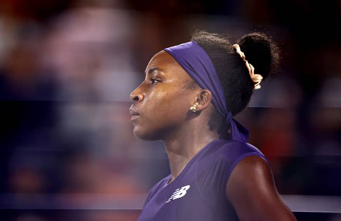 Coco Gauff successful  action, focused connected  the match, wearing a headband and diversion  top