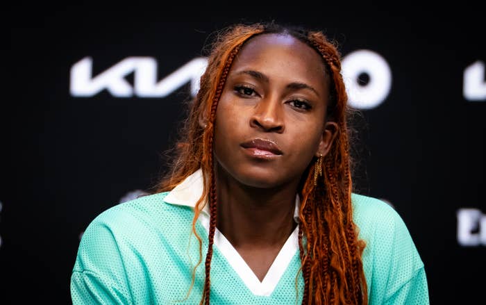 Coco Gauff with agelong  hairsbreadth  successful  braids wearing a casual sports jersey, sitting against a backdrop astatine  an event