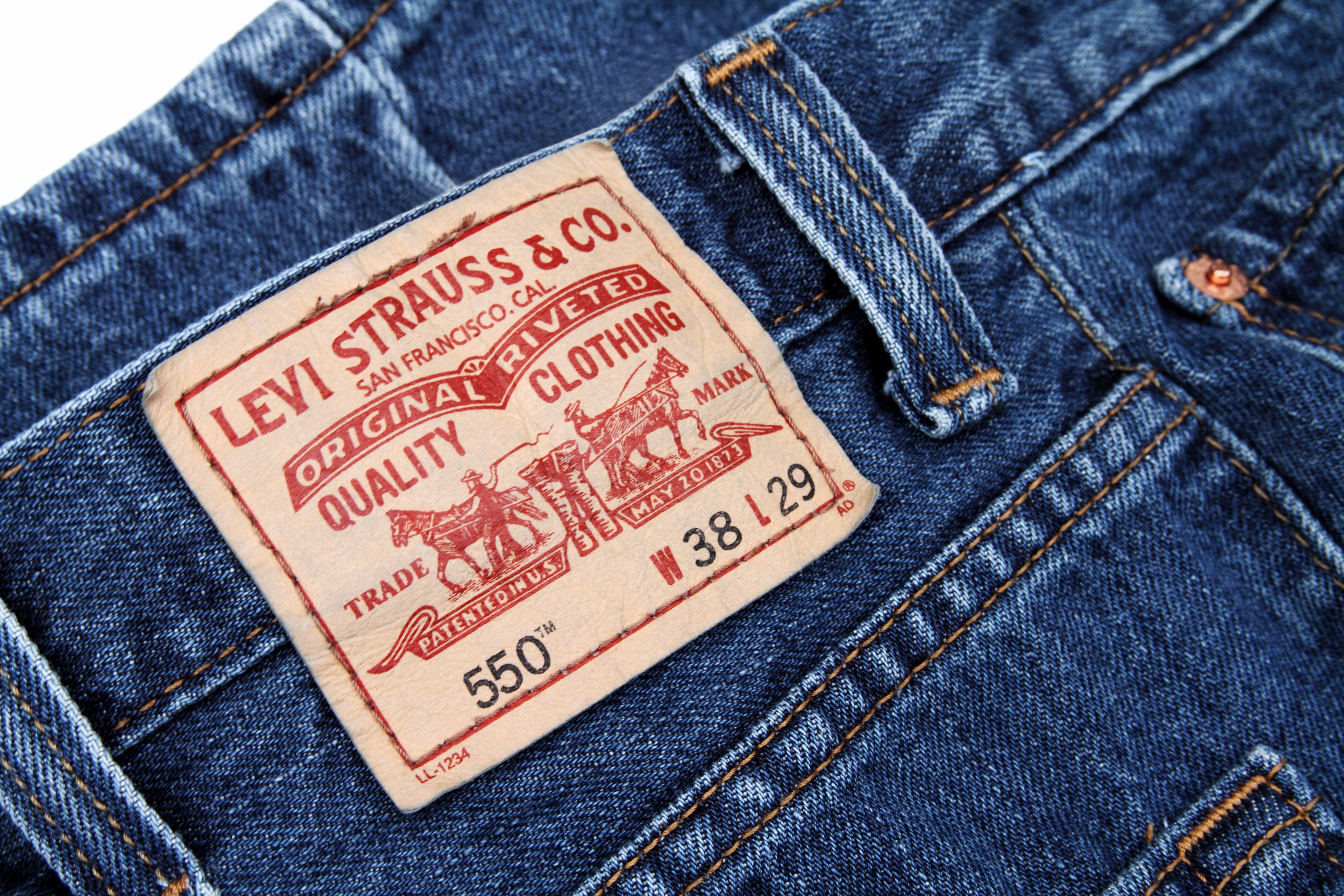 Close-up of a Levi's jeans waistband showing the iconic brownish  statement   with classical  logo and merchandise  details