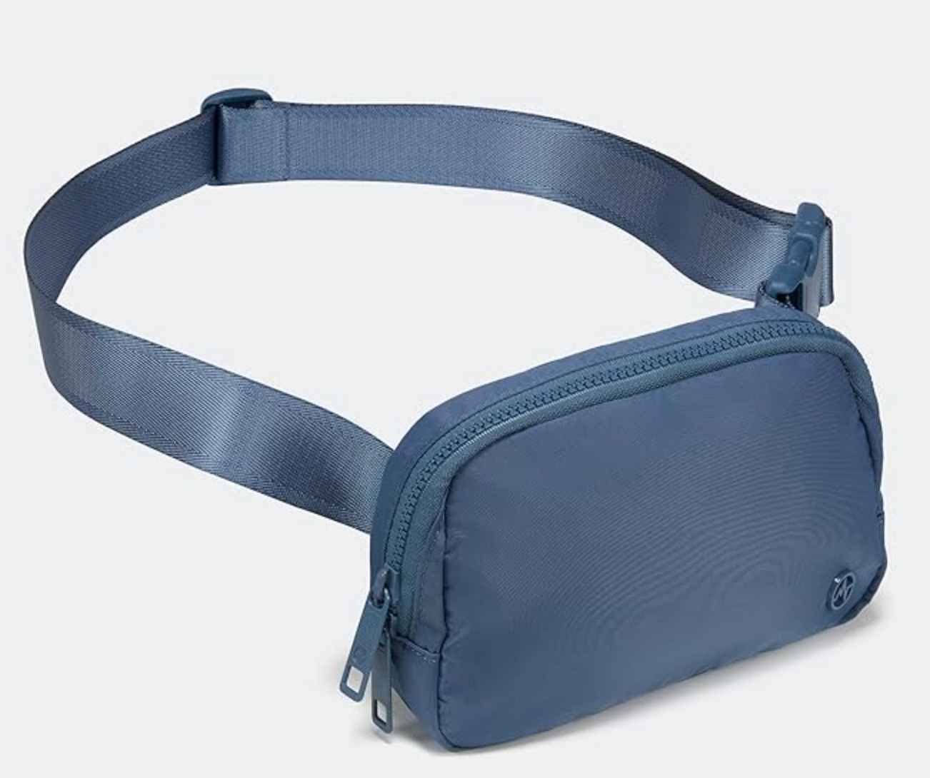 Tas selempang berwarna biru dengan tali yang dapat disesuaikan dan penutup ritsleting, cocok untuk jalan-jalan santai