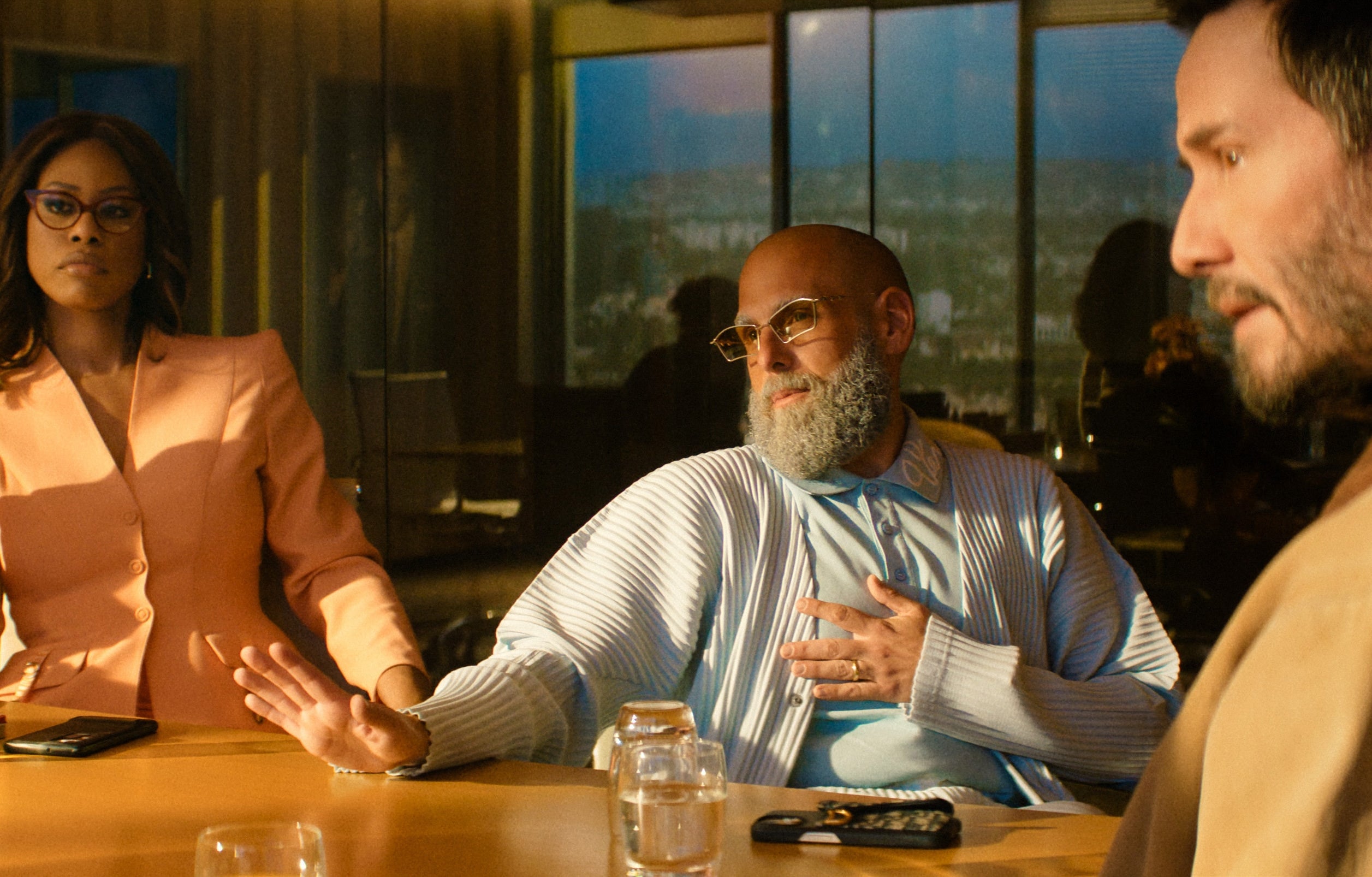 Three radical beryllium astatine a league table. One wears a ceremonial suit, different a casual sweater, and the 3rd a jacket. They are engaged successful conversation