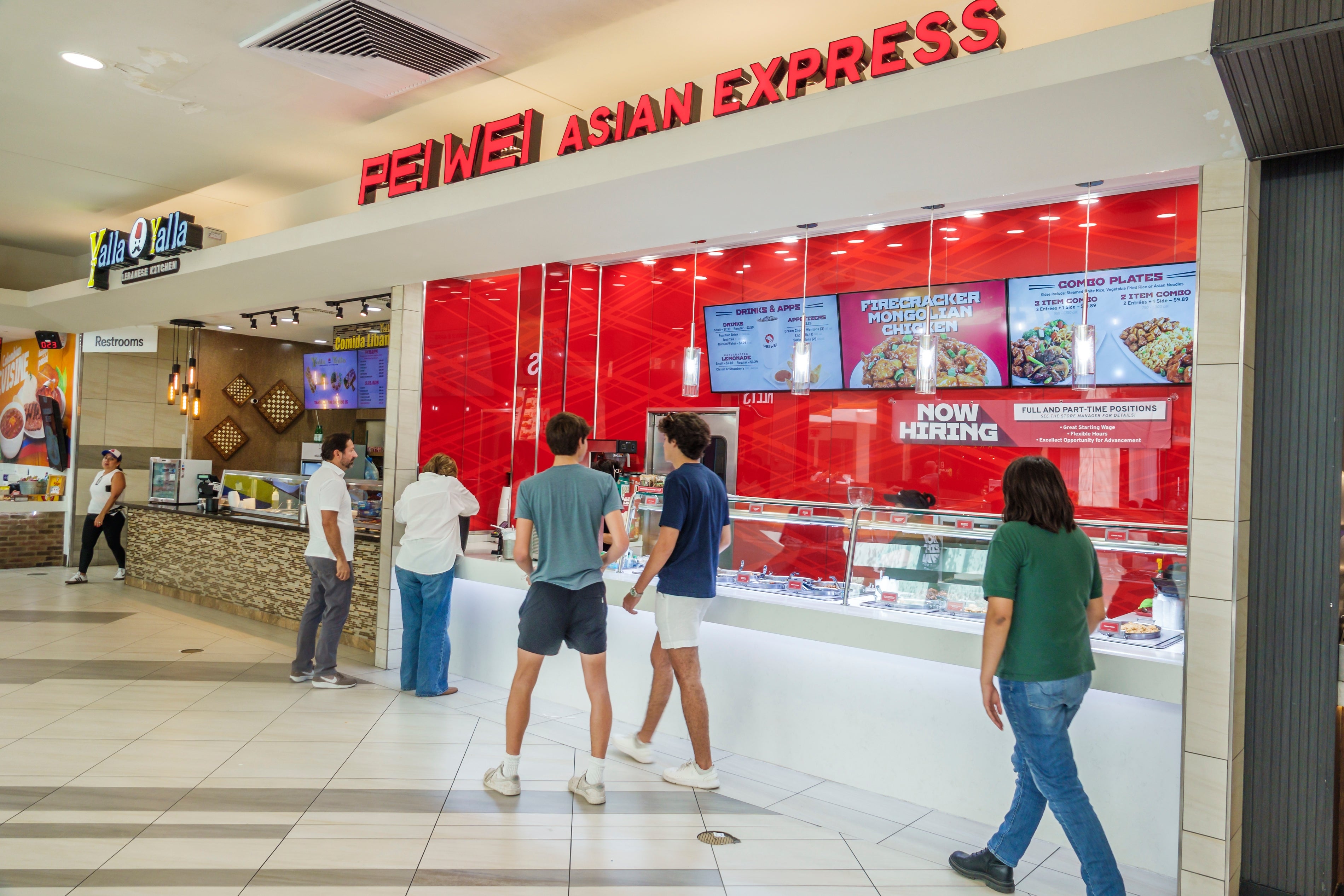 People basal   astatine  a nutrient  tribunal  antagonistic  labeled "PEI WEI ASIAN EXPRESS" with a "Now Hiring" motion   visible