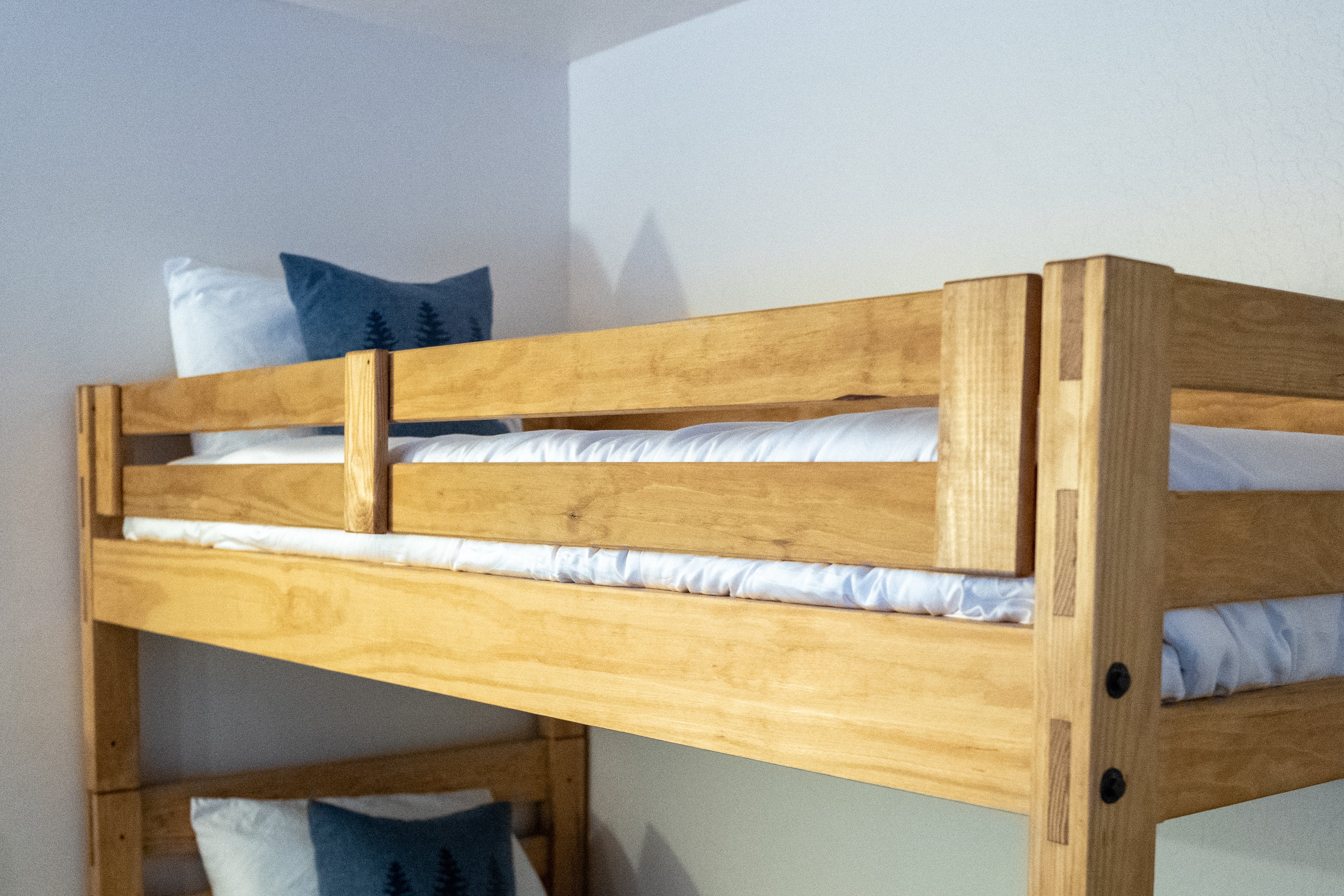 Wooden bunk furniture  with pillows, 1  connected  each   bunk, successful  a elemental  country   setting