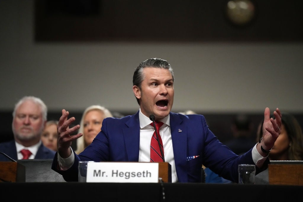A antheral successful a suit, identified arsenic Mr. Hegseth, speaks passionately astatine a hearing, gesturing with unfastened arms. People are seated down him