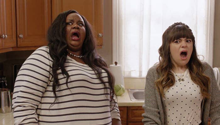 Two radical   successful  a kitchen, some  with shocked expressions. One wears a striped shirt, and the different   wears a polka dot garment  with a cardigan