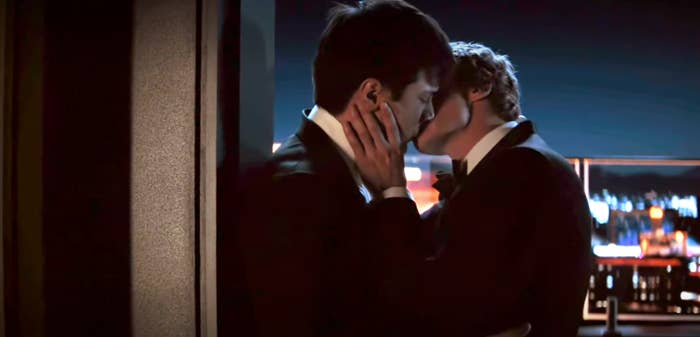 Two radical   wearing suits stock  a romanticist  buss  connected  a metropolis  balcony astatine  night