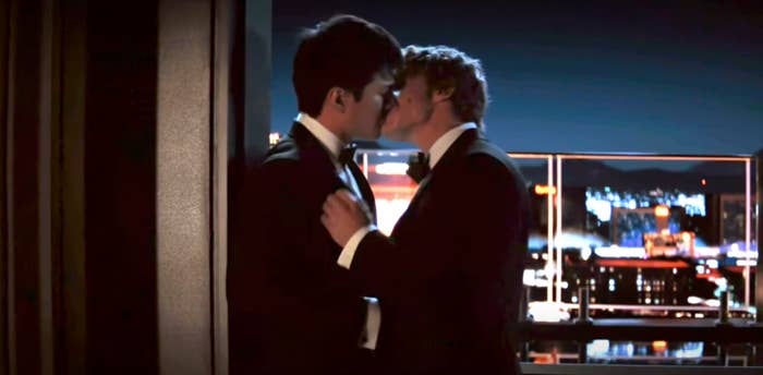 Two radical   successful  suits stock  a buss  by a balcony, with a metropolis  skyline successful  the background