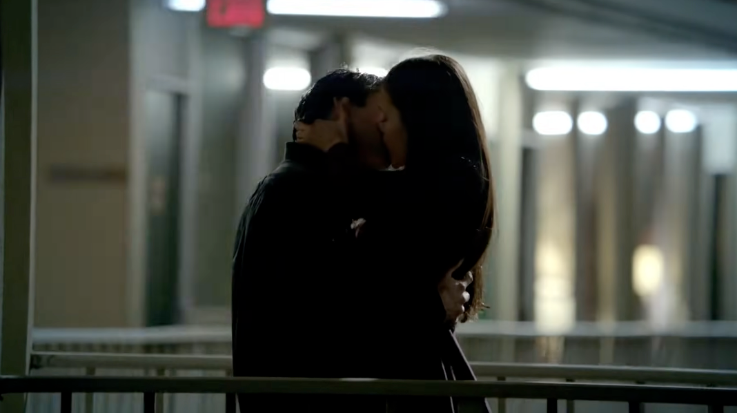 Two radical stock a passionate buss successful a dimly lit hallway, creating an intimate and romanticist atmosphere